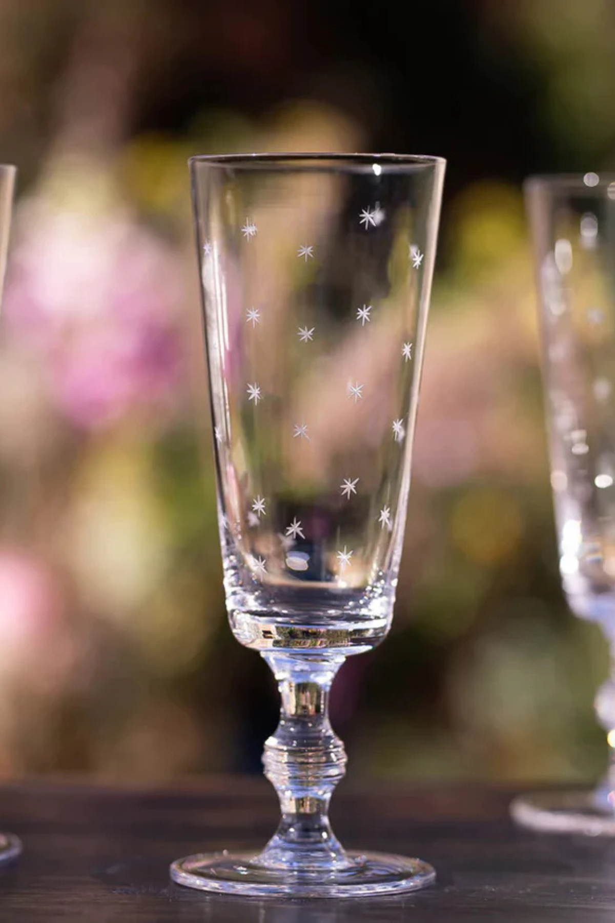 A Set of Four Crystal Champagne Flutes with Stars Design
